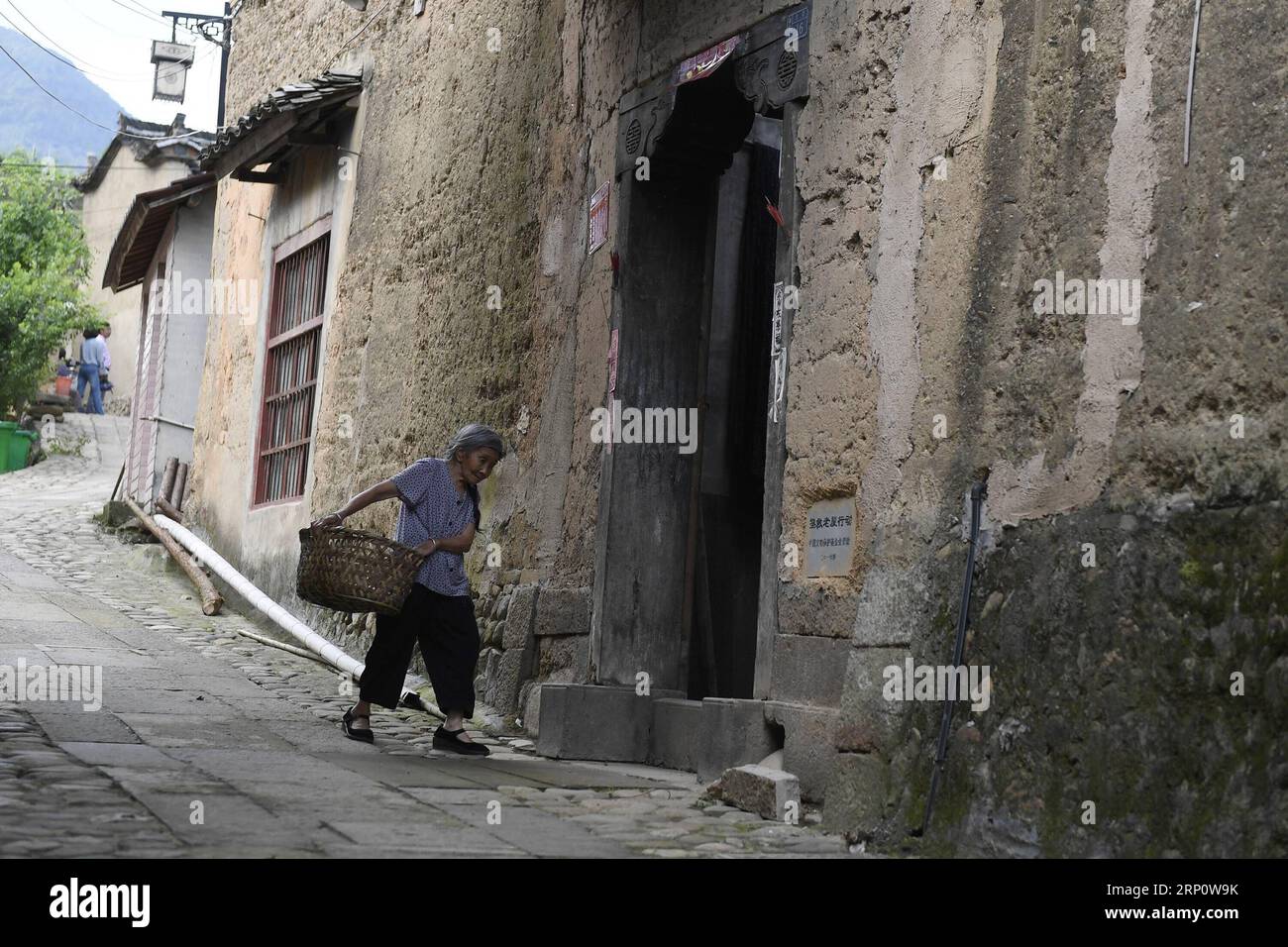 (180526) -- SONGYANG, May 26, 2018 -- A villager walks back home at a repaired ancient house in Hengzhang Village, Songyang County of east China s Zhejiang Province, May 25, 2018. A program to restore ancient houses has been put into operation since January of 2016 here in Songyang. By far, restoring work has been undergoing in 142 ancient houses and about 120 have finished repair. ) (zwx) CHINA-ZHEJIANG-SONGYANG-ANCIENT HOUSE-RESTORATION (CN) HuangxZongzhi PUBLICATIONxNOTxINxCHN Stock Photo