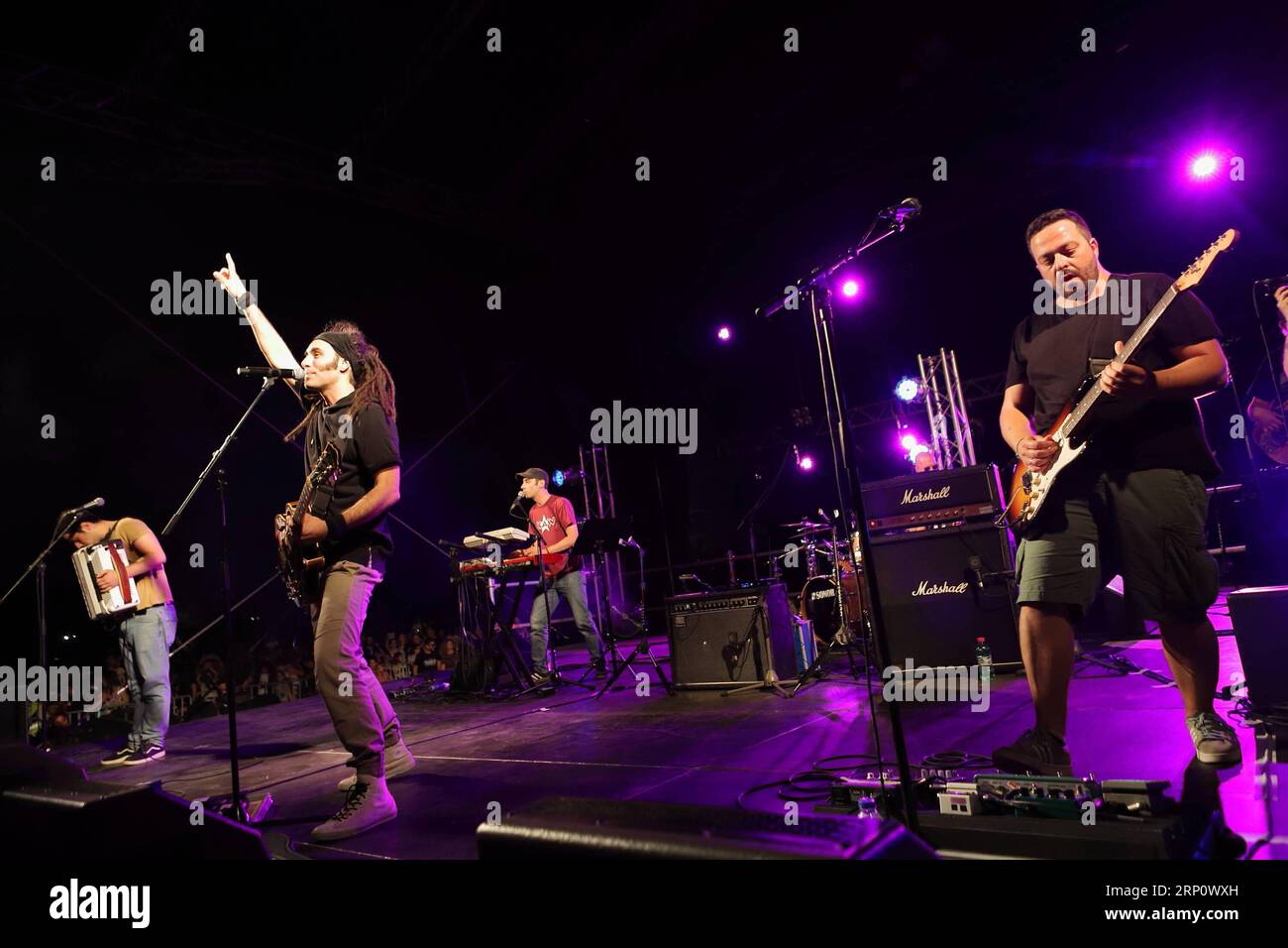 (180527) -- ATHENS, May 27, 2018 -- Locomondo, one of the most successful bands in Greece, play on stage at Stavros Niarchos Foundation Cultural Center in Athens, Greece, May 26, 2018. With a great party, featuring Locomondo, one of the most successful bands in Greece, Stavros Niarchos Foundation Cultural Center (SNFCC) welcomed the summer. More than 10,000 people showed up on Saturday evening at the Great Lawn of the park in Faliro Athens by the seaside to dance and sing with their favorite Greek band.) (djj) TO GO WITH XINHUA STORY: Athens residents welcome summer with outdoor concerts GREEC Stock Photo