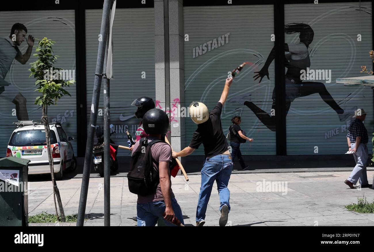 (180530) -- ATHENS, May 30, 2018 -- Protesters throw red paint as they clash with riot police during a 24-hour general strike in central Athens, Greece, on May 30, 2018. Greece was gripped on Wednesday by a 24-hour nationwide general strike called by trade unions to protest ongoing austerity. ) GREECE-ATHENS-GENERAL STRIKE MariosxLolos PUBLICATIONxNOTxINxCHN Stock Photo