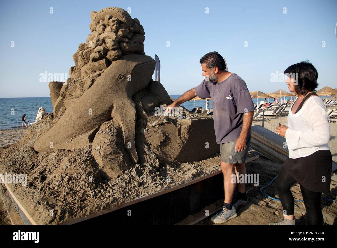 (180605) -- HERAKLION (GREECE), June 5, 2018 -- Greek sculptors Andreas Arapakis (L) and Amalia Florou work at Ammoudara beach, Heraklion, Greece, June 5, 2018. Ammoudara Professional Sand Sculpting Festival is held here to raise public awareness on plastic pollution. ) GREECE-HERAKLION-SAND SCULPTING FESTIVAL StefanosxRapanis PUBLICATIONxNOTxINxCHN Stock Photo