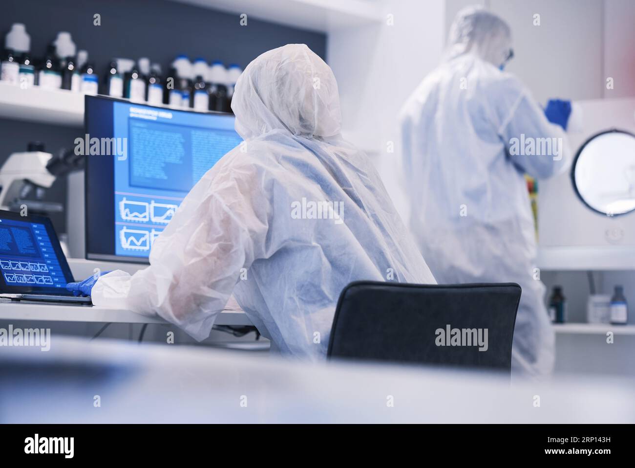 Future, research and science team in an investigation of hazard, virus and in a chemistry laboratory with computer. DNA, collaboration and medical Stock Photo