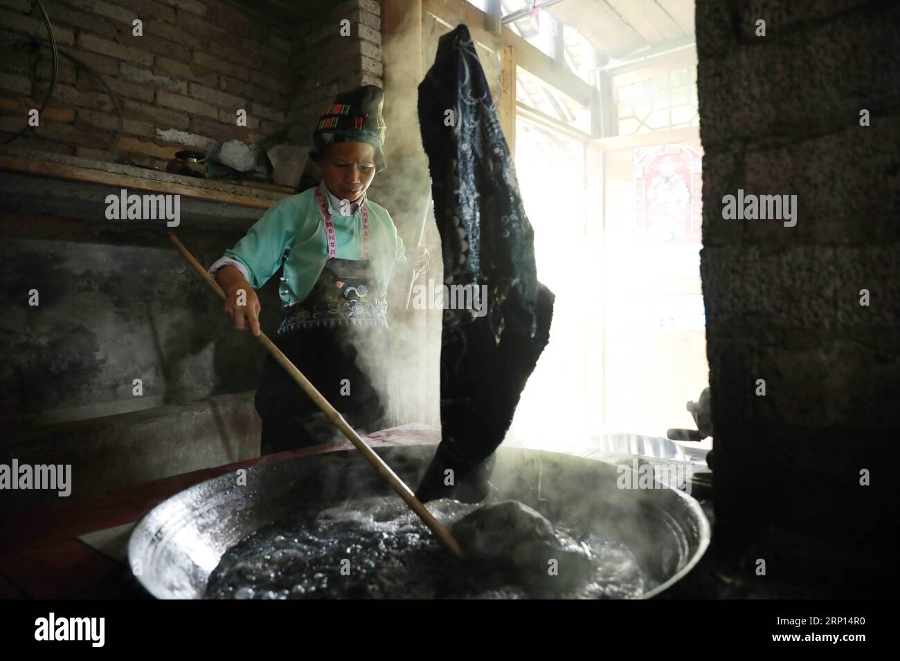 (180609) -- DANZHAI, June 9, 2018 -- A woman of miao ethnic group makes batik products in Yangwu Town of Danzhai County, southwest China s Guizhou Province, June 8, 2018. Miao people s batik handicraft is one of China s national intangible heritages. As the major inheritance site of Miao people s batik handicraft, Jijia Miao Village of Yangwu Town has a good many excellent craftspeople, but the inconvenient traffic had impeded the sale of batik products to the outside before 2017. With the increasing improvement of traffic and assistance from local government and volunteers since 2017, people Stock Photo