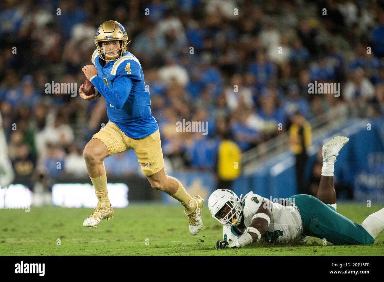 UCLA quarterback Ethan Garbers (4) runs with the ball past Coastal ...