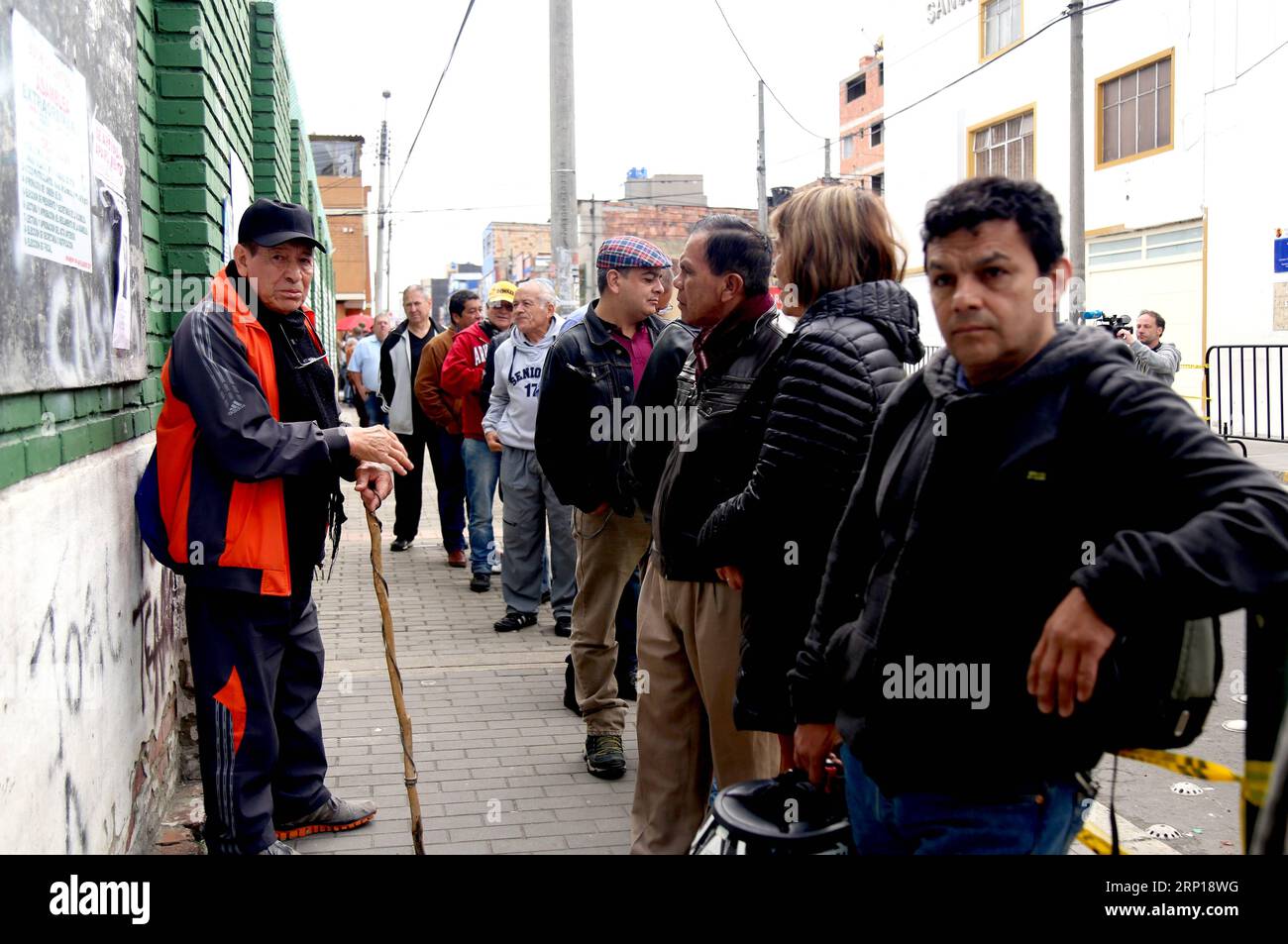 (180617) -- BOGOTA, June 17, 2018 -- People queue to vote at a polling station in Bogota, Colombia, on June 17, 2018. A total of 11,233 polling stations opened on Sunday morning to allow more than 36 million Colombians to elect a successor to President Juan Manuel Santos. ) ***MANDATORY CREDIT*** ***NO SALES-NO ARCHIVE*** ***EDITORIAL USE ONLY*** ***COLOMBIA OUT*** COLOMBIA-BOGOTA-PRESIDENTIAL VOTING-SECOND ROUND COLPRENSA/AlvaroxTavera PUBLICATIONxNOTxINxCHN Stock Photo