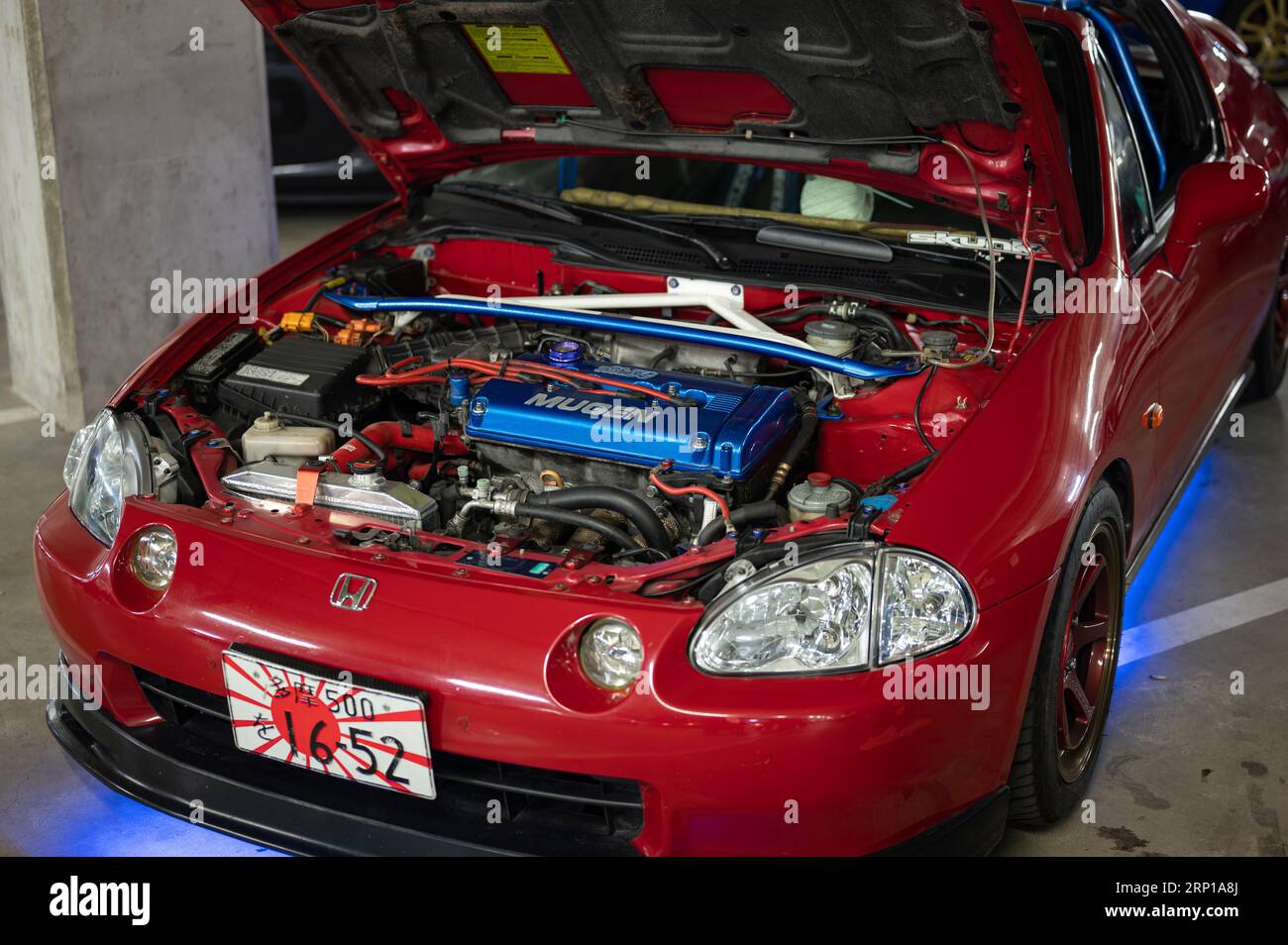 The modified Mugen engine of the red Honda CR-X Del Sol parked in the parking lot Stock Photo
