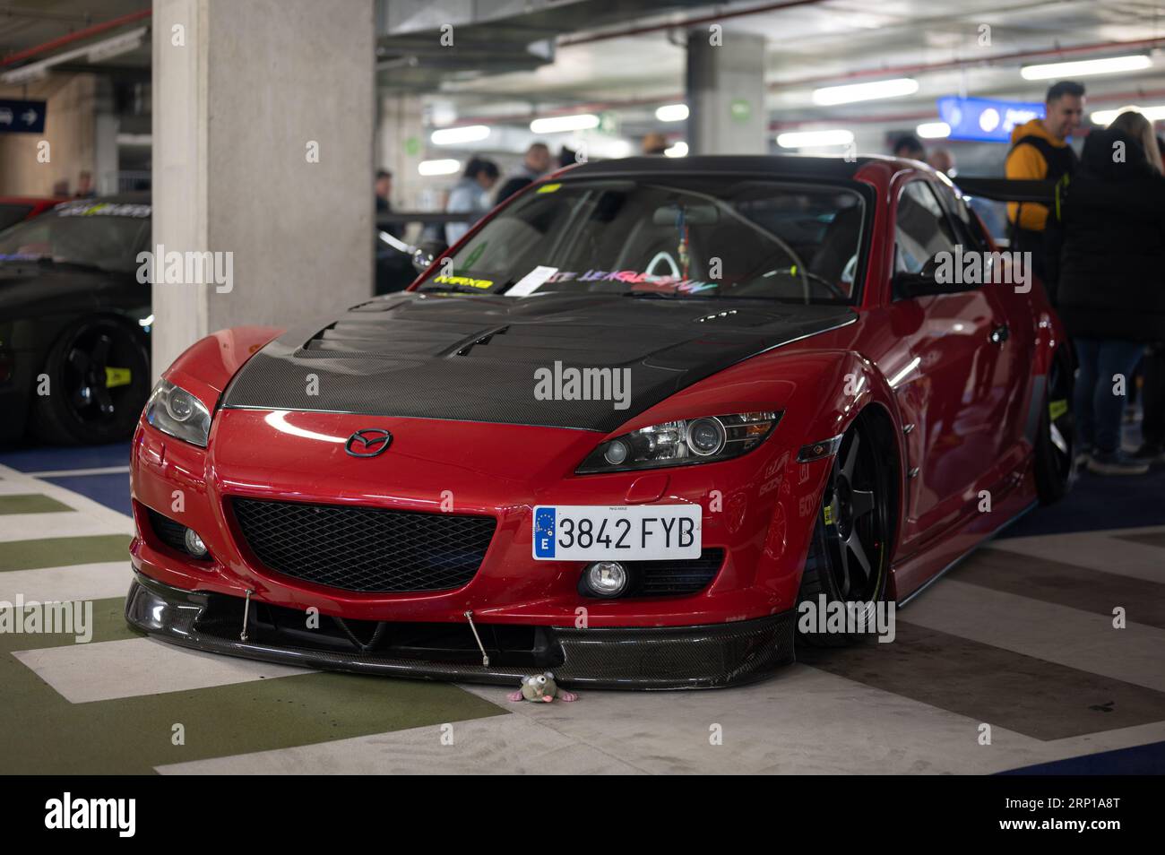 A red Mazda RX8 with black hood and lip modified for illegal racing Stock Photo