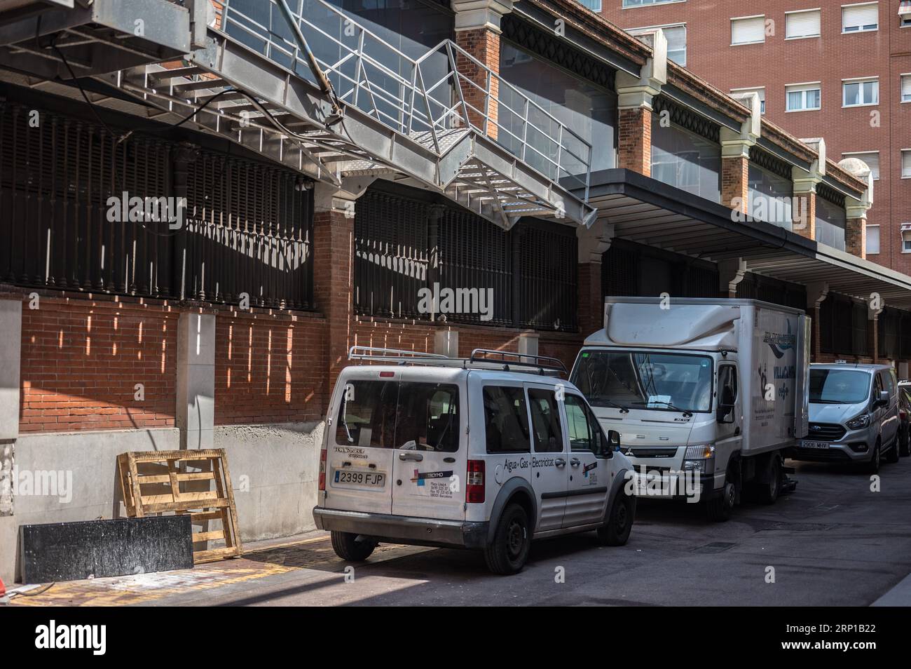 A dark alleyway at the back of the market, the vans and trucks unloaded and parked Stock Photo