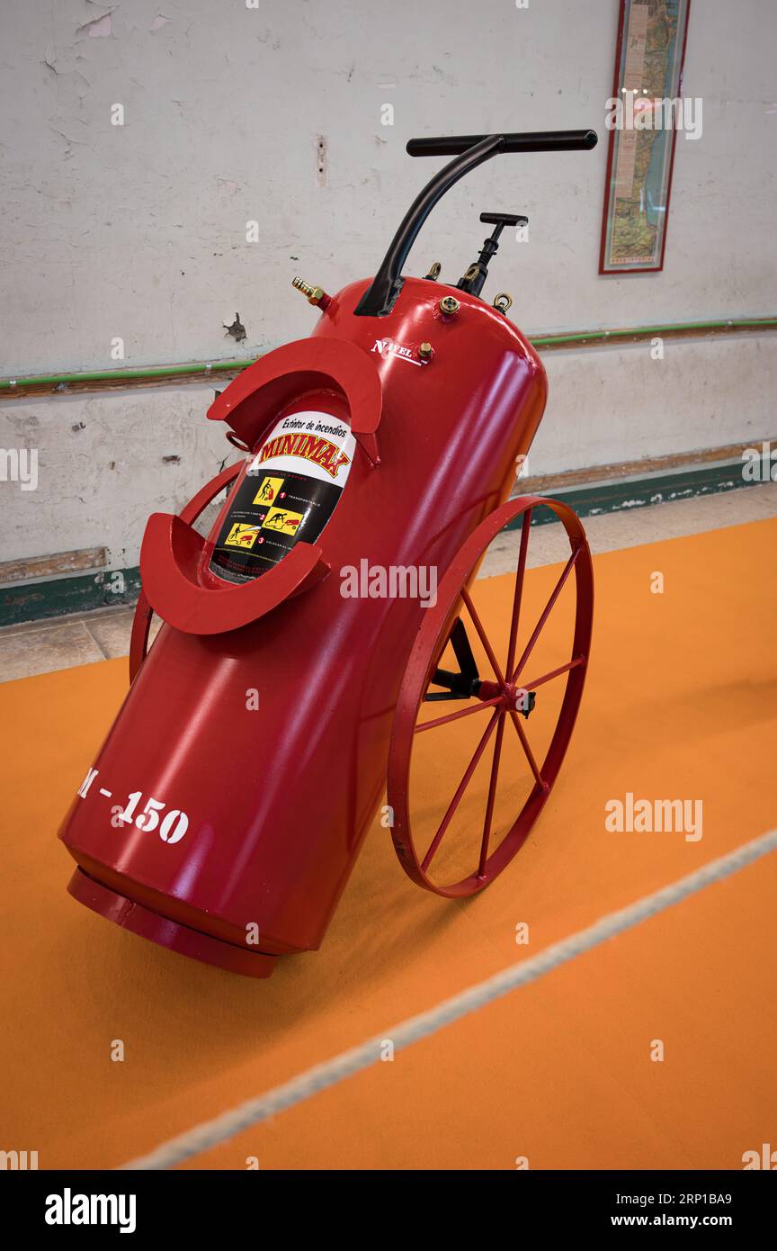 A closeup of an old red car fire extinguisher Stock Photo