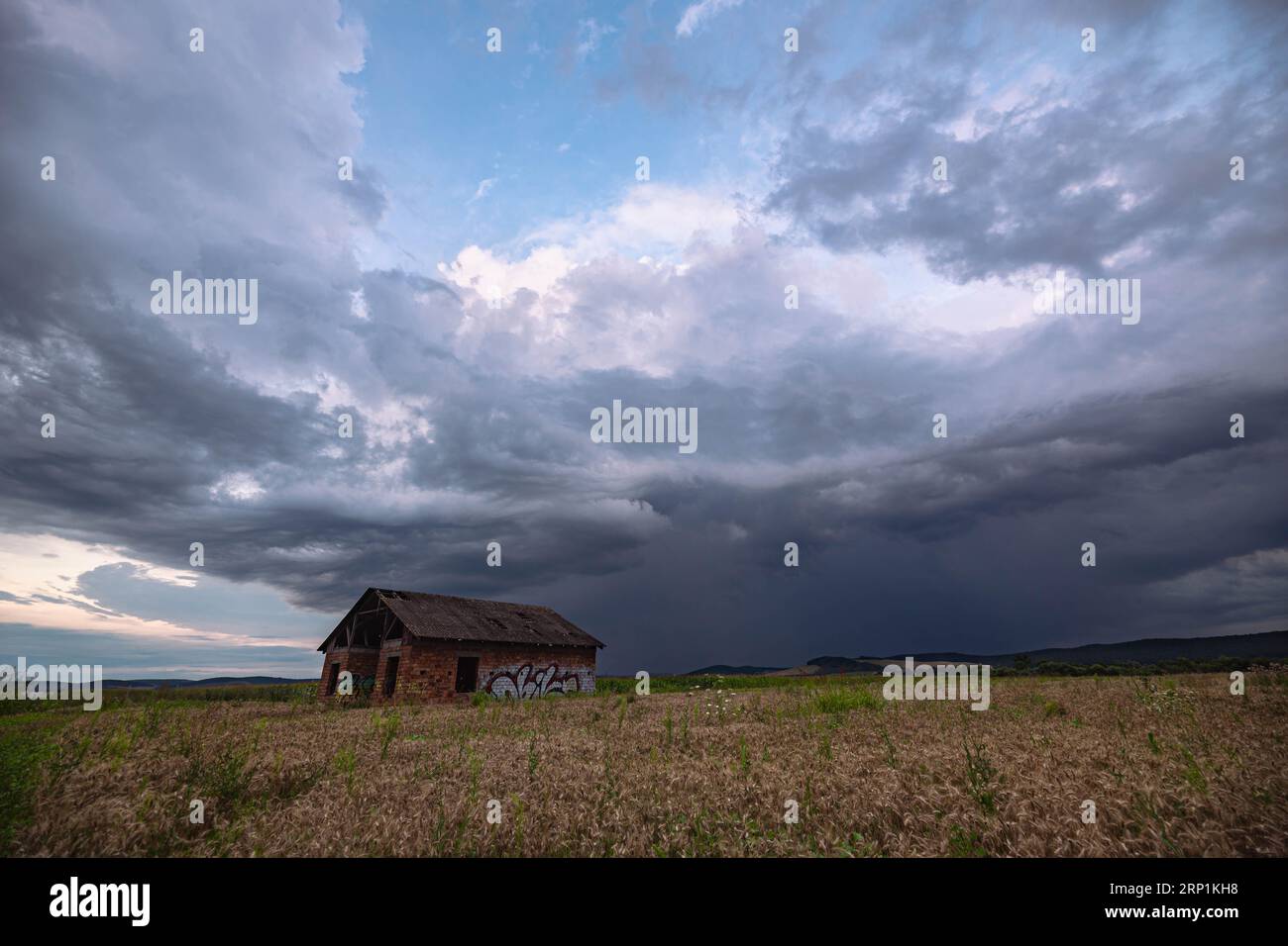 Dramatic looking Cumulonimbus storm cloud over the countryside of Transylvania. Stock Photo