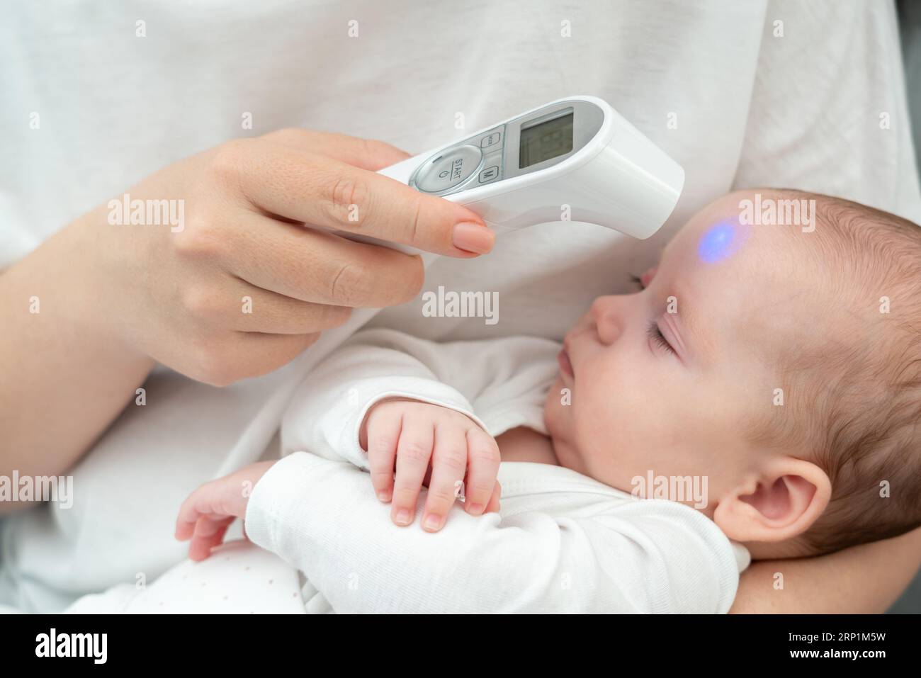 Woman's touch: digital health care for infant. Concept of evolving motherly instincts with technology Stock Photo