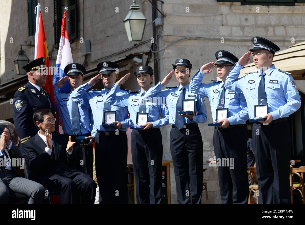 (180715) -- DUBROVNIK, July 15, 2018 -- Zeljko Prsa, Deputy General Police Director of Croatia, gives police badges to Chinese police officers during the launching ceremony of joint police patrol between China and Croatia in Dubrovnik, Croatia, on July 15, 2018. Six uniformed Chinese police officers started joint patrol with their Croatian counterparts here on Sunday. ) (lrz) CROATIA-DUBROVNIK-TOURISM-JOINT POLICE PATROL GaoxLei PUBLICATIONxNOTxINxCHN Stock Photo