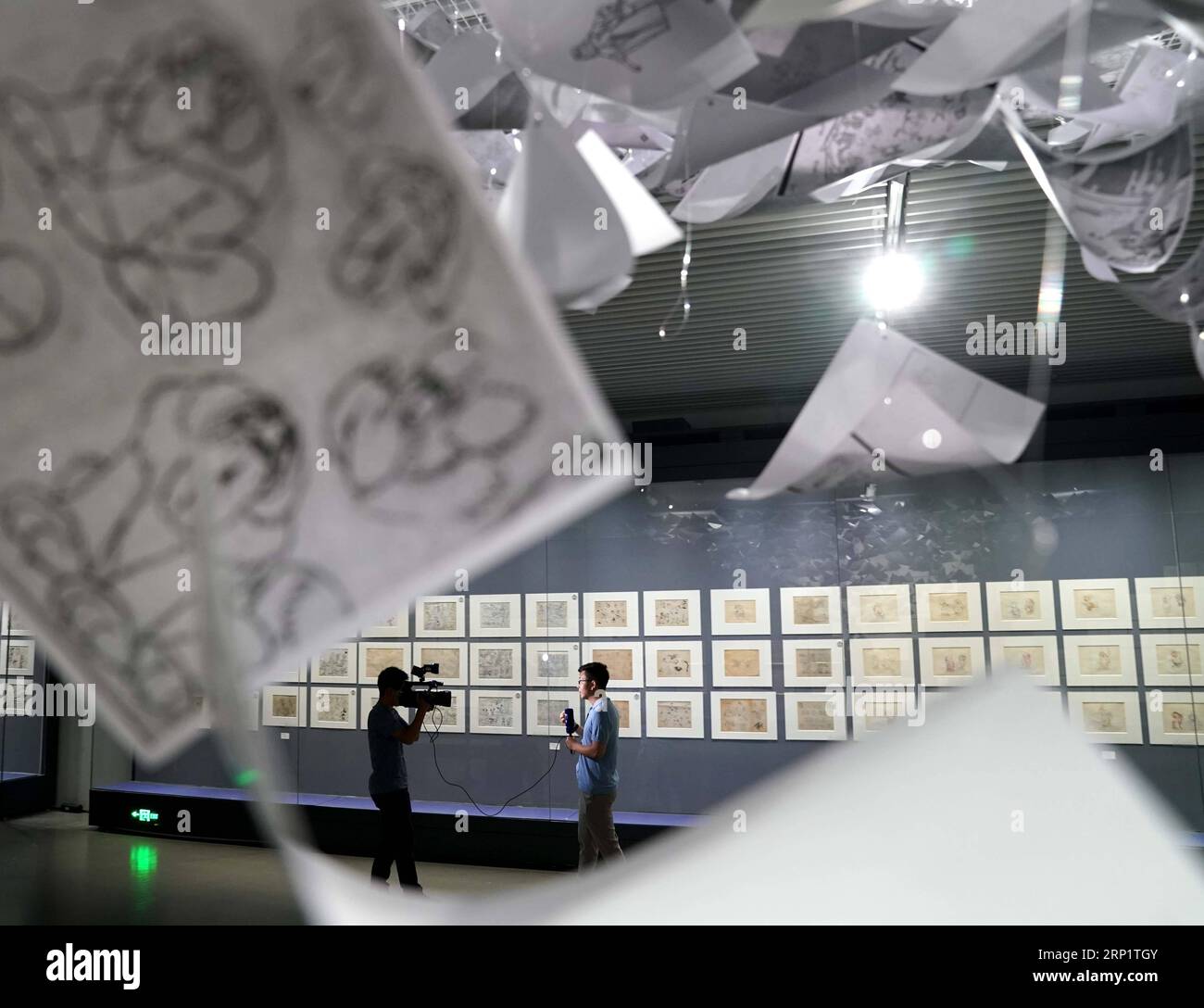 (180723) -- BEIJING, July 23, 2018 -- Correspondents work at an animation exhibition at National Museum of Classic Books in Beijing, capital of China, July 23, 2018. Over 400 original animation artworks and celluloid pieces were displayed in this exhibition. ) (hxy) CHINA-BEIJING-ANIMATION-EXHIBITION (CN) YinxGang PUBLICATIONxNOTxINxCHN Stock Photo