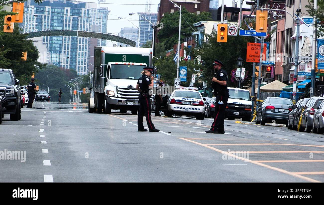(180724) -- TORONTO, July 24, 2018 -- Local policemen close the Danforth Street to search for evidence in Toronto, Canada, July 23, 2018. An 18-year-old female university student and a 10-year-old girl were killed, and 13 others injured when a gunman opened fire in a busy Toronto street Sunday night. The suspected shooter, a 29-year-old Toronto man, also died. ) (gj) CANADA-TORONTO-SHOOTING LixHaitao PUBLICATIONxNOTxINxCHN Stock Photo