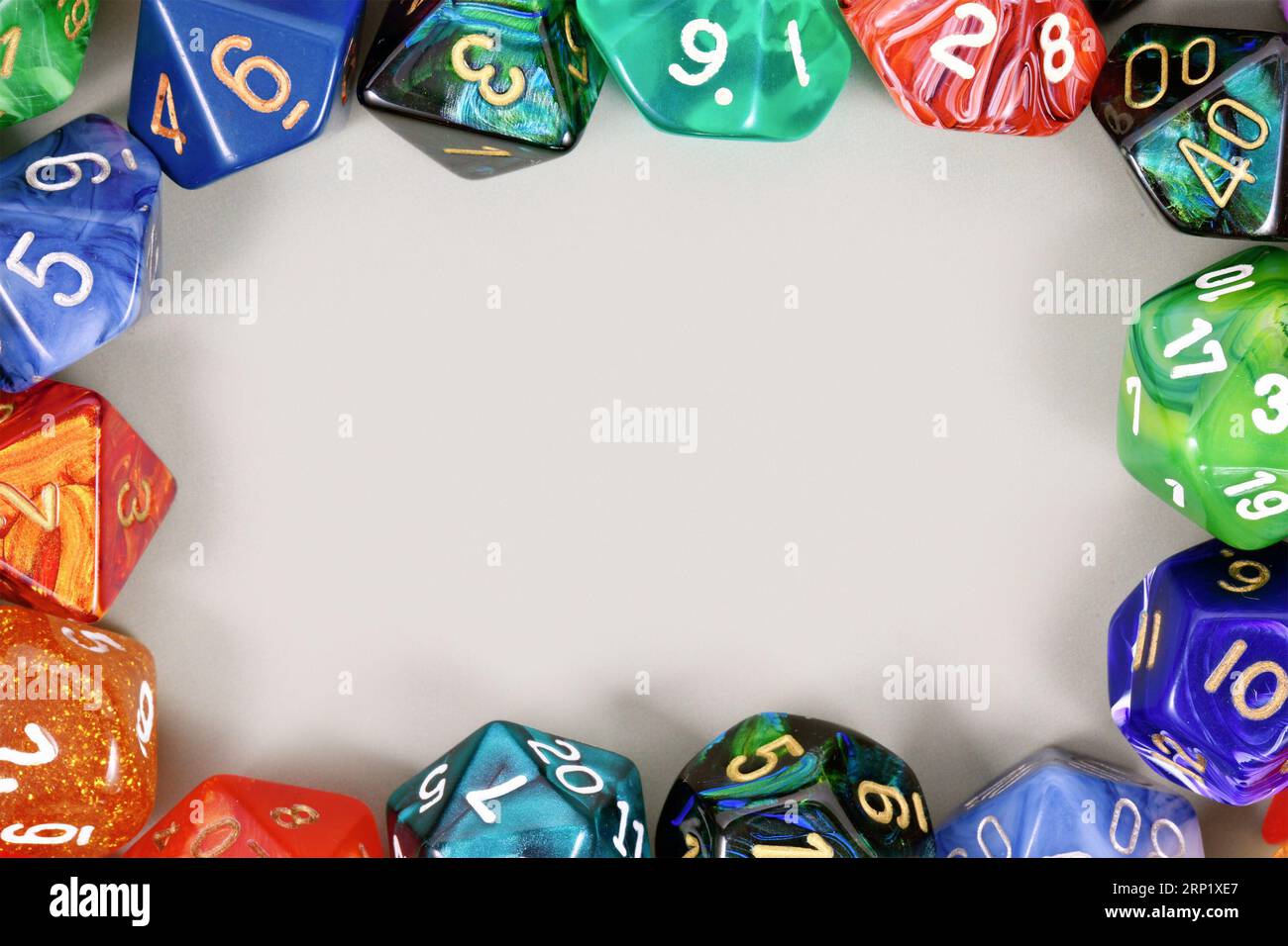 Colorful role playing RPG dice forming border around gray background with copy space Stock Photo