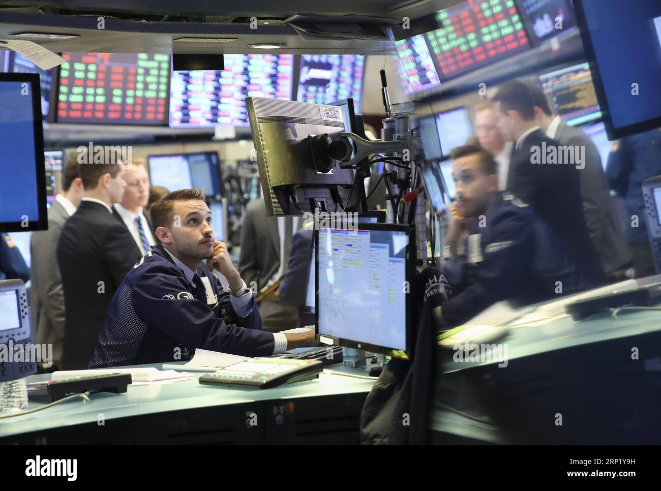 (180806) -- NEW YORK, Aug. 6, 2018 -- Traders work at the New York Stock Exchange in New York, the United States, Aug. 6, 2018. U.S. stocks closed higher on Monday as investors digested a batch of second-quarter corporate earnings reports. The Dow Jones Industrial Average rose 39.60 points, or 0.16 percent, to 25,502.18. The S&P 500 increased 10.05 points, or 0.35 percent, to 2,850.40. The Nasdaq Composite Index rose 47.66 points, or 0.61 percent, to 7,859.68. ) U.S.-NEW YORK-STOCKS WangxYing PUBLICATIONxNOTxINxCHN Stock Photo