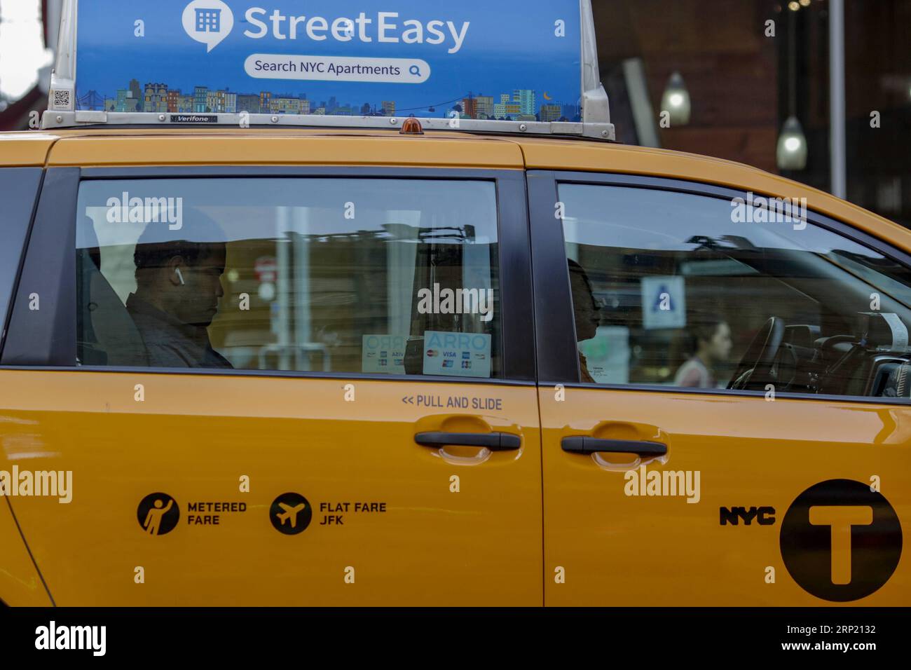 180809 -- NEW YORK, Aug. 9, 2018 -- A yellow cab is seen on a street in Manhattan, New York City, the United States, Aug. 9, 2018. New York City Council passed regulations on for-hire vehicle industry on Wednesday, placing a year-long cap on the number of for-hire vehicles on the road. The app-based transportation industry in New York City includes about 80,000 vehicles, dwarfing the city s 13,587 medallion taxis, according to a latest study by the New School for the Taxi and Limousine Commission.  U.S.-NEW YORK-FOR-HIRE VEHICLES-REGULATIONS LixMuzi PUBLICATIONxNOTxINxCHN Stock Photo