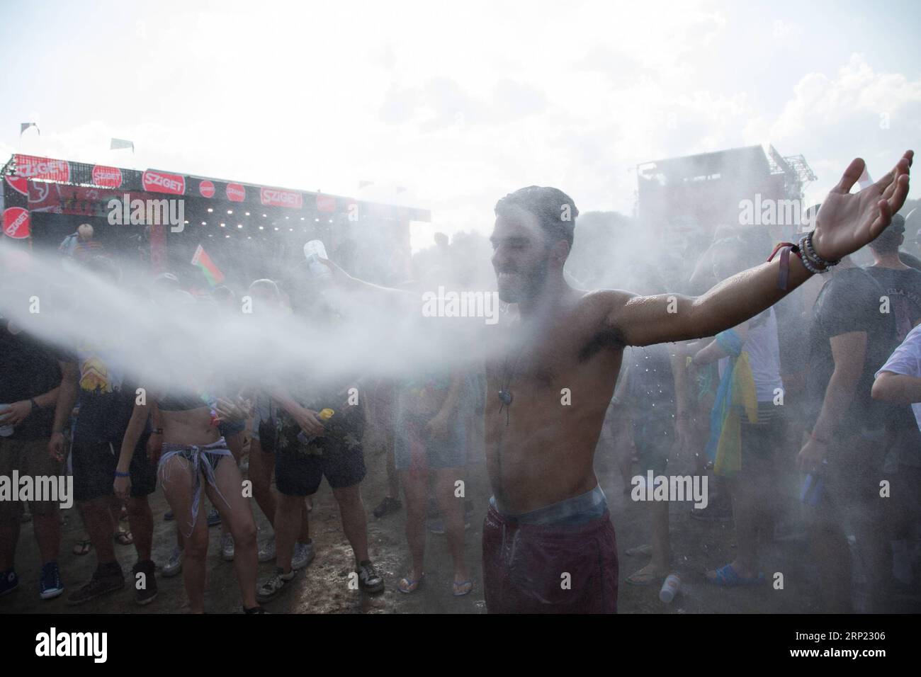 (180814) -- BUDAPEST, Aug. 14, 2018 -- Revellers cool down in a spray of water as they party in the record heat in front of the Main Stage at the Sziget Festival held in Budapest, Hungary on Aug. 13, 2018. ) (gj) HUNGARY-BUDAPEST-SZIGET FESTIVAL AttilaxVolgyi PUBLICATIONxNOTxINxCHN Stock Photo