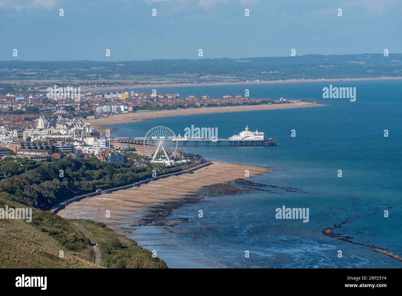 Long shot view from Beachy Head towards the Big Wheel, beach and pier at Eastbourne, East Sussex, UK. Stock Photo