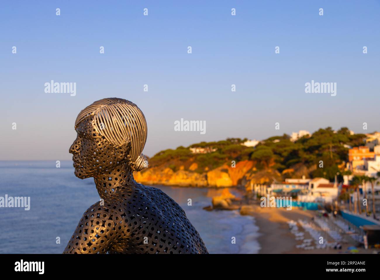 A metal sculpture by artist Carlos de Oliveira Correia looks out over the Atlantic Ocean from the viewing platform on Olhos des Augua beach shortly Stock Photo