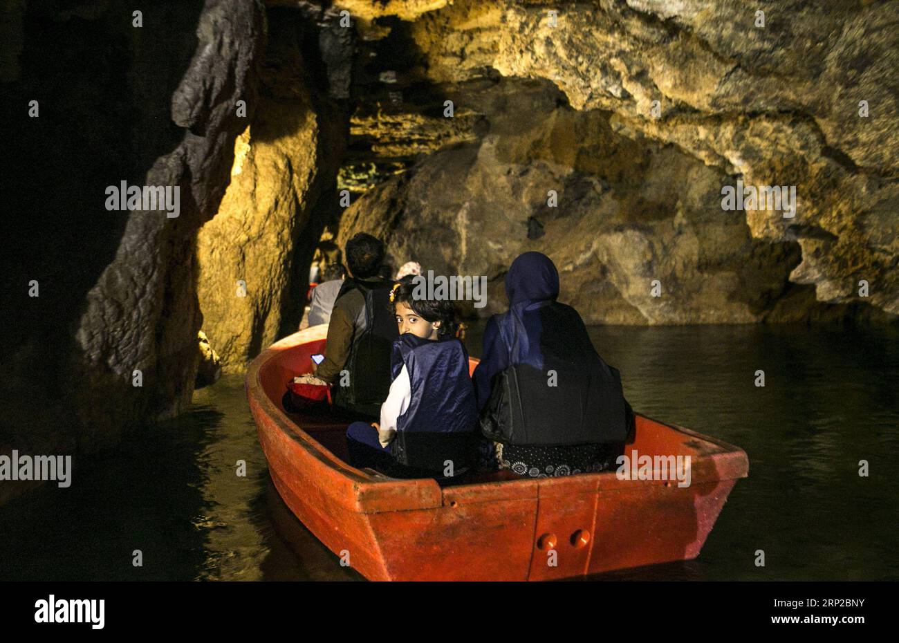 (180829) -- HAMEDAN, Aug. 29, 2018 -- Tourists visit Alisadr cave on a boat in Hamedan province, western Iran, on Aug. 27, 2018. Alisadr Cave attracts thousands of tourists every year. ) (qxy) IRAN-HAMEDAN-ALISADR CAVE AhmadxHalabisaz PUBLICATIONxNOTxINxCHN Stock Photo