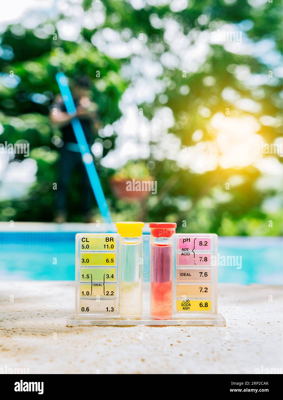 Pool water PH tester kit on the edge of the swimming pool. Tester kit