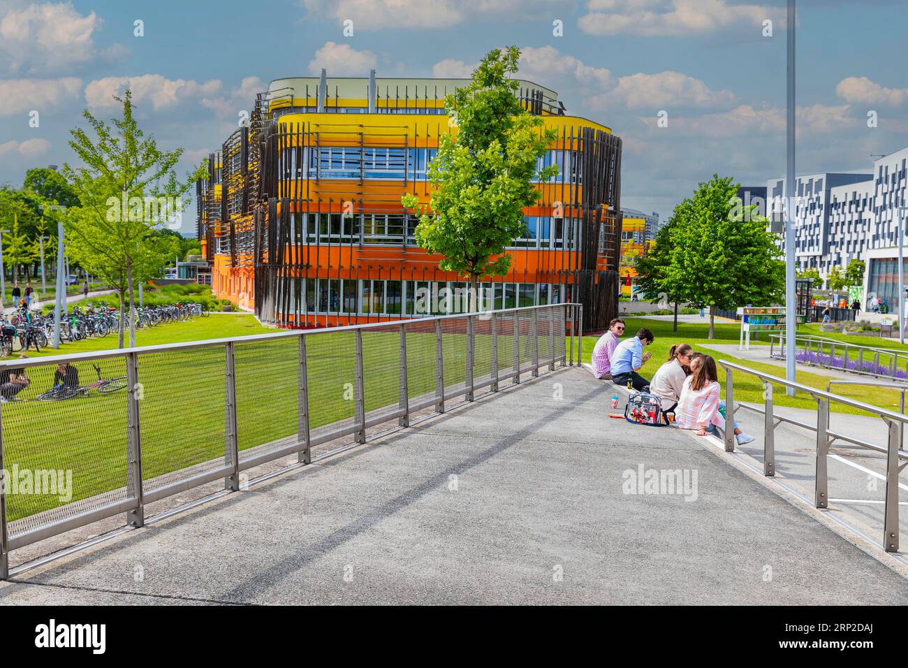 Students sitting in front of modern buildings on the campus of the University of Economics WU, modern architecture, Leopoldstadt, Vienna, Austria Stock Photo