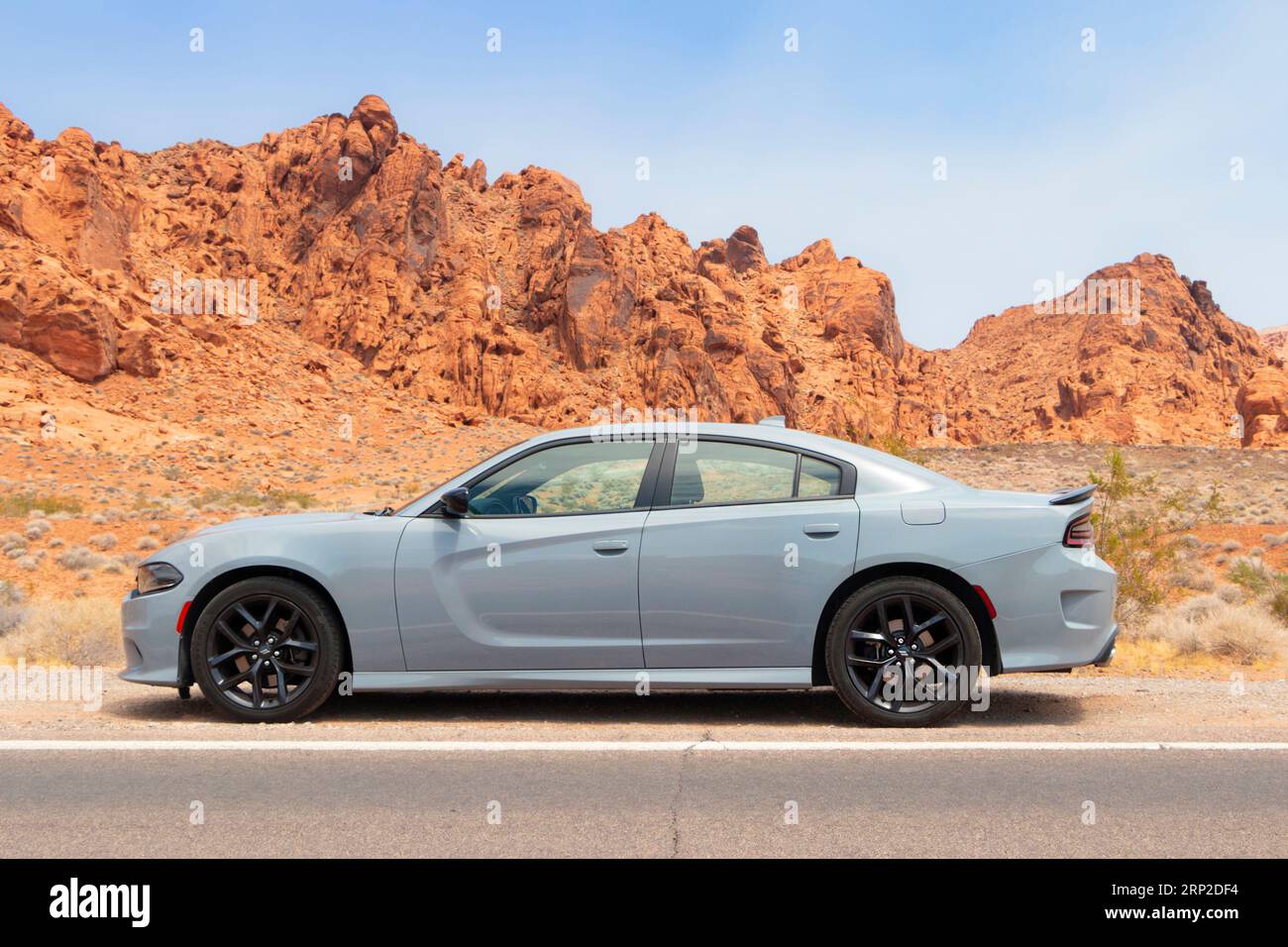 grey gray mucle car Dodge charger side view parked in utah desert Stock Photo