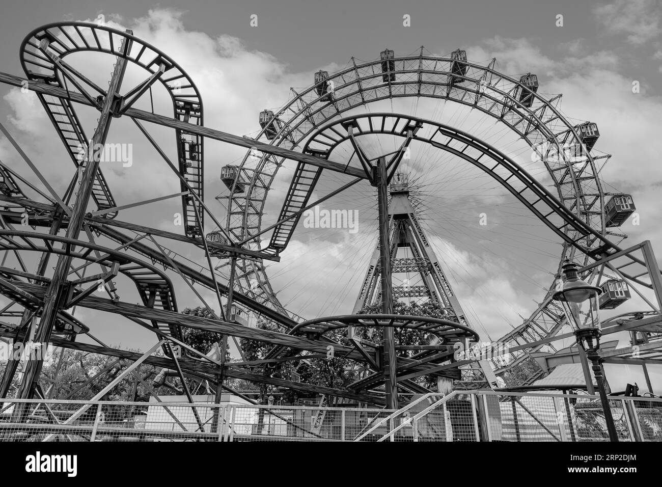 Rusty rail of an old roller coaster, in the back the Viennese Ferris wheel, black and white photo, Prater, Vienna, Austria Stock Photo