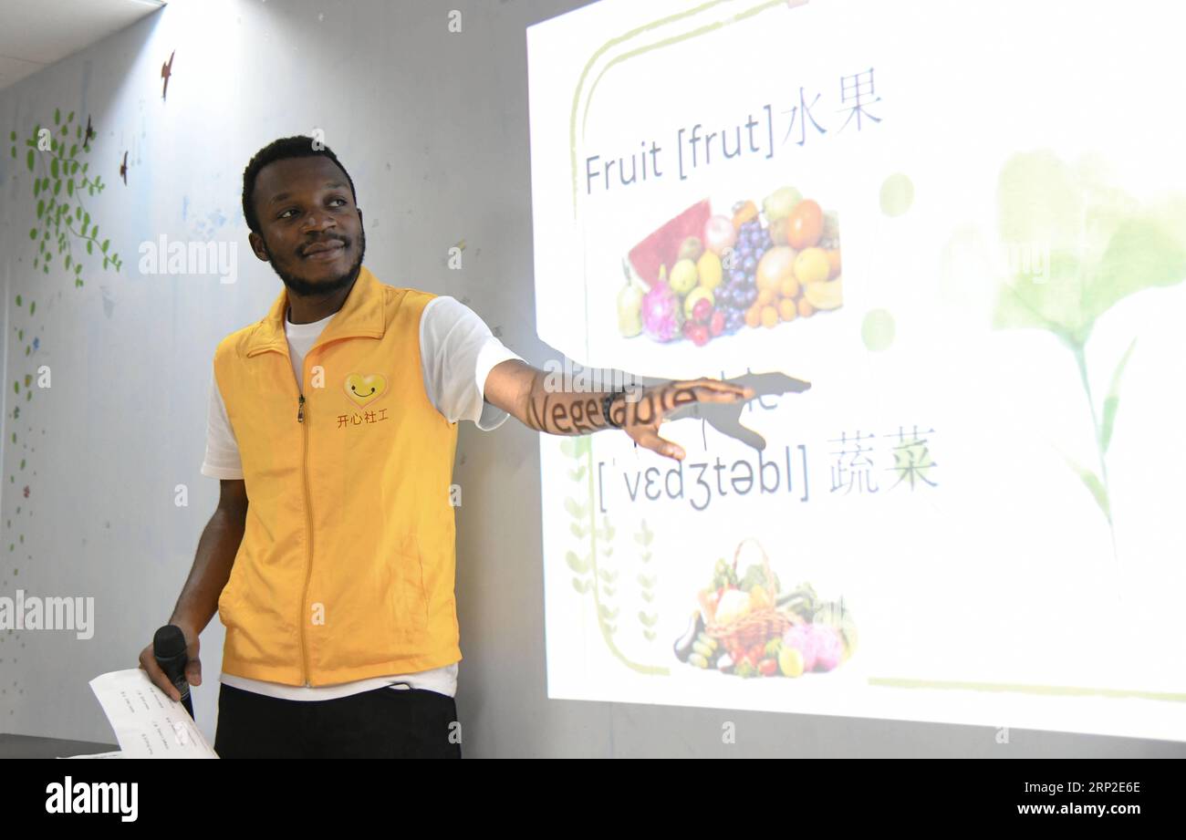 (180901) -- GUANGZHOU, Sept. 1, 2018 -- African student Kabey Heritier Lweny teaches Chinese senior citizens English in Guangzhou, south China s Guangdong Province, Aug. 29, 2018. Kabey, who comes from the Democratic Republic of Congo, came to Guangdong University of Technology as a Chinese language major about a year ago. The rich Chinese cuisine and culture have always appealed to him, but it s by taking part in various volunteer activities that has made him embrace the life in Guangzhou ever more closely. I grew to learn more about the Chinese traditions and lifestyles as I joined Chinese v Stock Photo