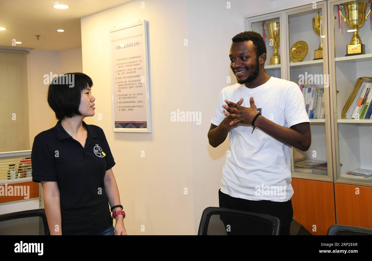 (180901) -- GUANGZHOU, Sept. 1, 2018 -- African student Kabey Heritier Lweny (R) and a fellow volunteer talk about their favorite Chinese songs in Guangzhou, south China s Guangdong Province, Aug. 29, 2018. Kabey, who comes from the Democratic Republic of Congo, came to Guangdong University of Technology as a Chinese language major about a year ago. The rich Chinese cuisine and culture have always appealed to him, but it s by taking part in various volunteer activities that has made him embrace the life in Guangzhou ever more closely. I grew to learn more about the Chinese traditions and lifes Stock Photo