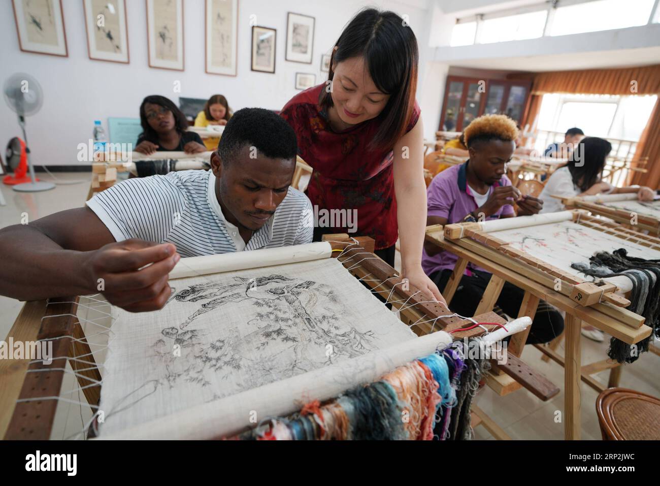 (180905) -- XINYU, Sept. 5, 2018 -- An African student learns embroidery under the coach of teacher Fu Aixiaing at Xinyu University in Xinyu, east China s Jiangxi Province, Sept. 5, 2018. The Xinyu university set up courses of embroidery and martial arts for African students to learn about Chinese culture as the new semester begins. ) CHINA-JIANGXI-AFRICAN STUDENT-CHINESE CULTURE (CN) SongxZhenping PUBLICATIONxNOTxINxCHN Stock Photo