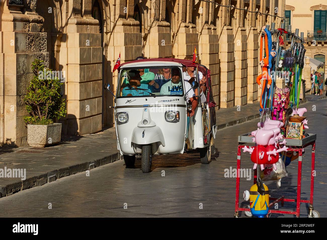 Ape, open motorised tricycle, tourists, Noto, baroque city, baroque angle, Southeast, Sicily, Italy Stock Photo