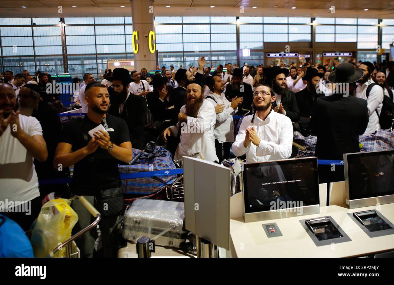 (180907) -- TEL AVIV, Sept. 7, 2018 -- Ultra-orthodox Jewish men from Breslov sect dance and sing as they check in to flights headed for Ukrainian city of Uman at Ben-Gurion International Airport near Tel Aviv, Israel, on Sept. 6, 2018. On the Jewish New Year in September, tens of thousands of religious Jews will fly to Uman to pray at the grave of Rabbi Nachman of Breslov, who founded the Hasidic Jewish movement named after him at the end of the 18th century. ) (yk) ISRAEL-BEN GURION AIRPORT-ORTHODOX JEW-PILGRIMS GilxCohenxMagen PUBLICATIONxNOTxINxCHN Stock Photo