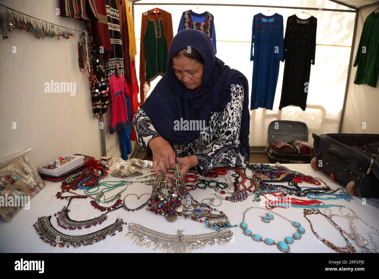 (180909) -- KABUL, Sept. 9, 2018 -- An Afghan woman arranges her products during a product exhibition which organized by women in Kabul, capital of Afghanistan, Sept. 4, 2018. )(yg) AFGHANISTAN-KABUL-PRODUCT EXHIBITION-WOMAN RahmatxAlizadah PUBLICATIONxNOTxINxCHN Stock Photo