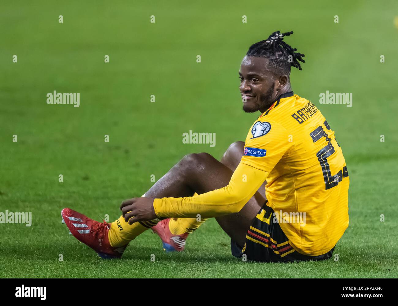 Brussels, Belgium - March 21, 2019. Belgium national football team striker Michy Batshuayi sitting on the pitch after a foul was committed on him duri Stock Photo
