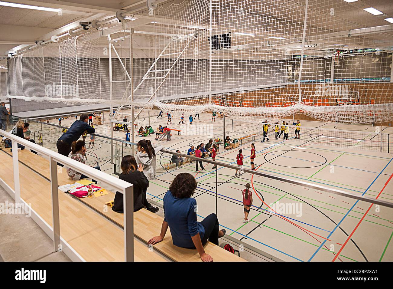 Gym, sports hall, spectators and active people, education, physical education, teaching mission, children's health, modern spacious building, primary Stock Photo