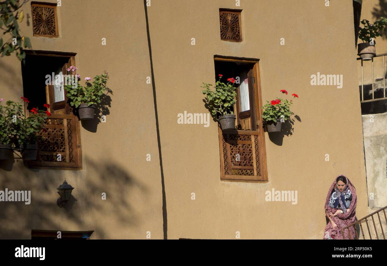 (180915) -- MASOULEH, Sept. 15, 2018 -- A woman walks in Masouleh, northern Iran, on Sept. 14, 2018. The historical town of Masouleh, famous for its interconnected buildings and courtyards and roofs serving as pedestrian areas similar to streets, has an attractive nature and architecture with an antiquity of more than 1,000 years. ) IRAN-MASOULEH-VIEW AhmadxHalabisaz PUBLICATIONxNOTxINxCHN Stock Photo