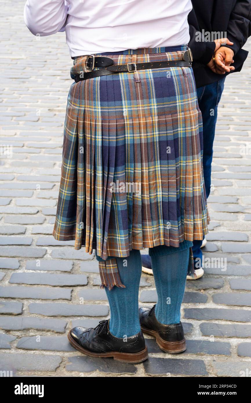 Unrecognizable man wearing traditional Scottish kilt with tartan cloth. Vertical shot Stock Photo