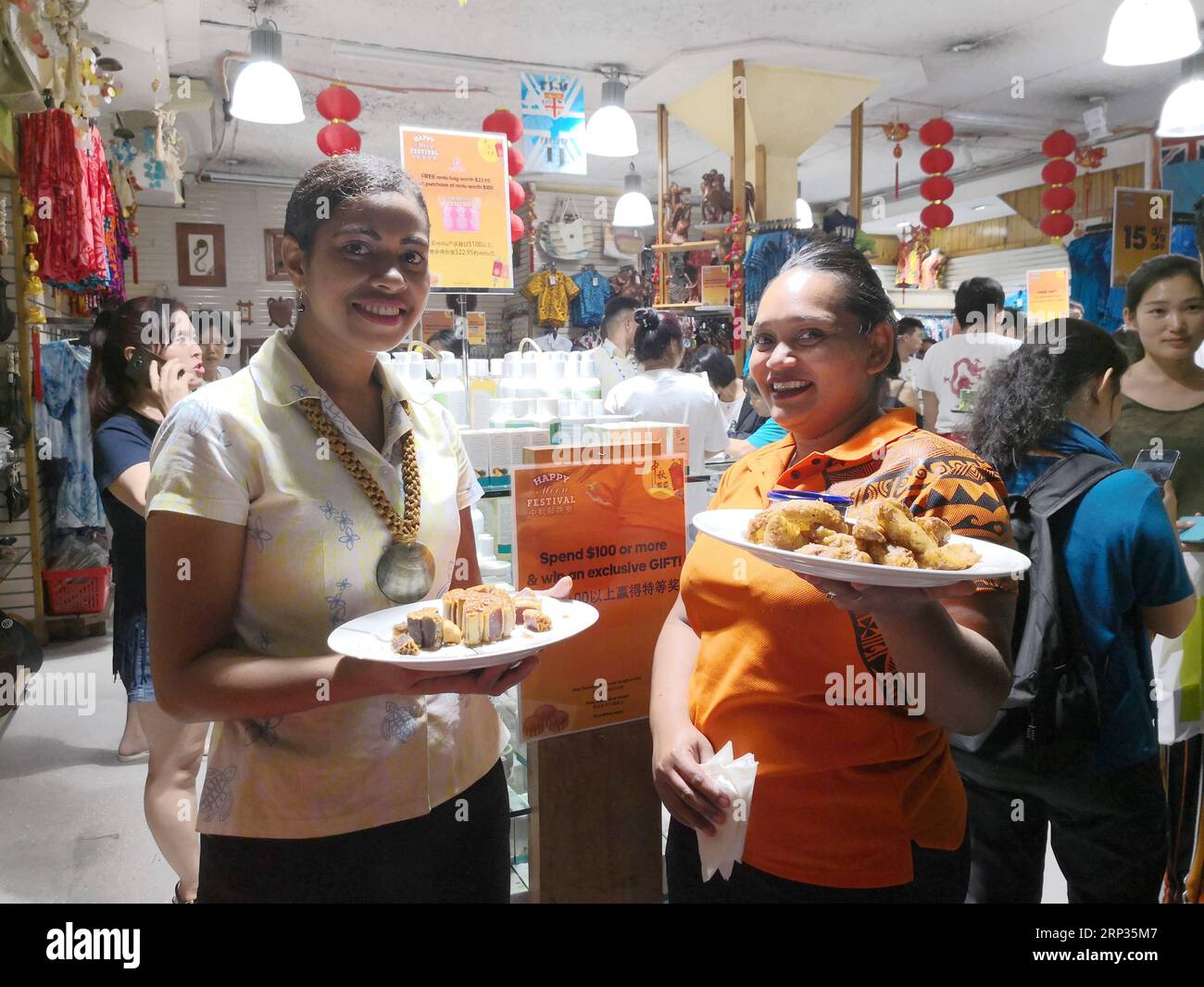 (180921) -- SUVA, Sept. 21, 2018 -- Sales assistants provide moon cakes for tasting at a shopping mall in Suva, Fiji, on Sept. 20, 2018. Shopping malls in Suva started their sales promotional activities before the upcoming Chinese Mid-Autumn Festival to attract more customers. ) FIJI-SUVA-CHINESE-FESTIVAL-BUSINESS ZhangxYongxing PUBLICATIONxNOTxINxCHN Stock Photo