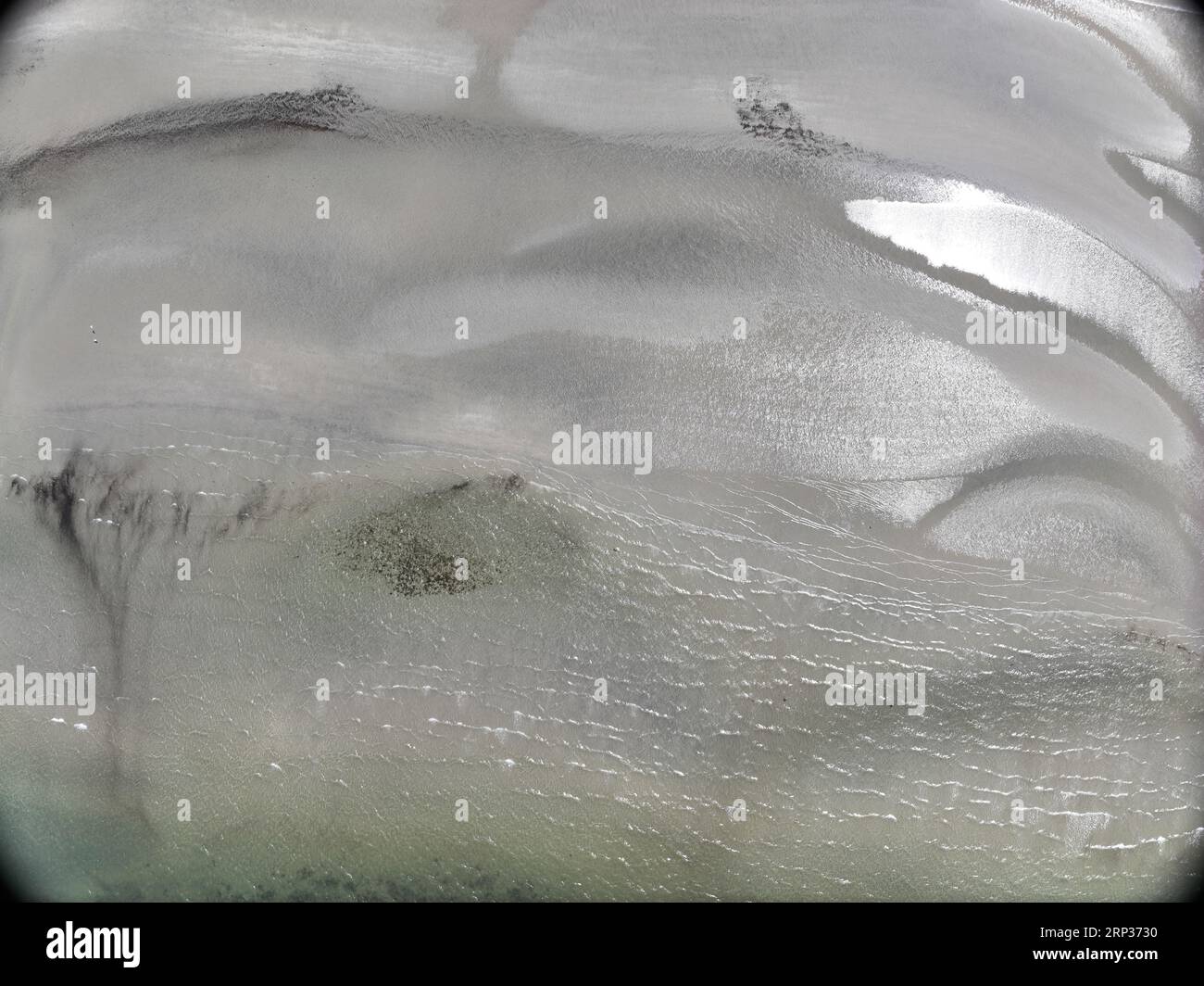 Aerial view of white rippling sandy beach and blue clear water in Lockhart River Stock Photo