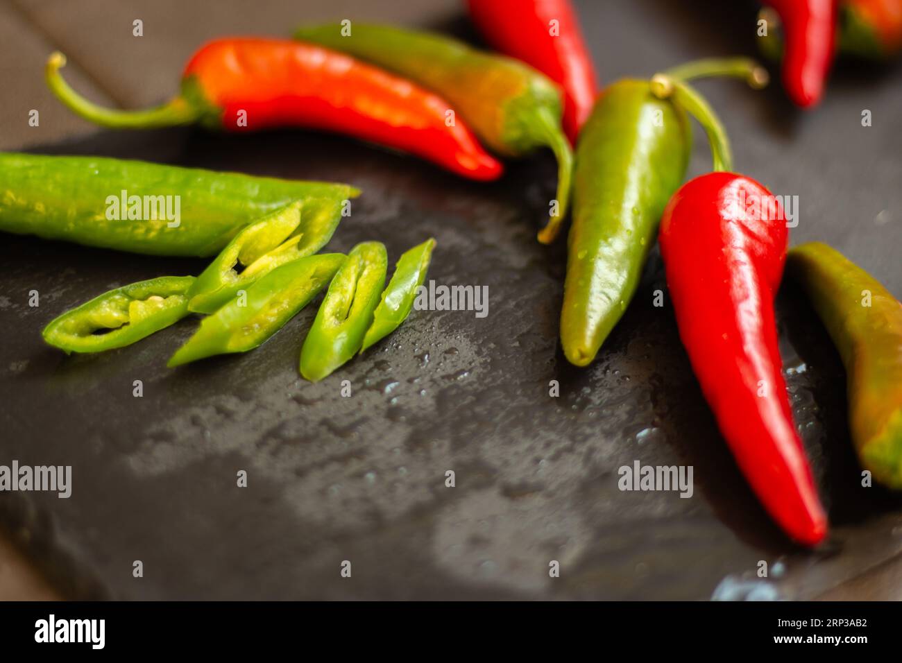 Red hot chilli peppers on black board with copy space. Heap of red and
