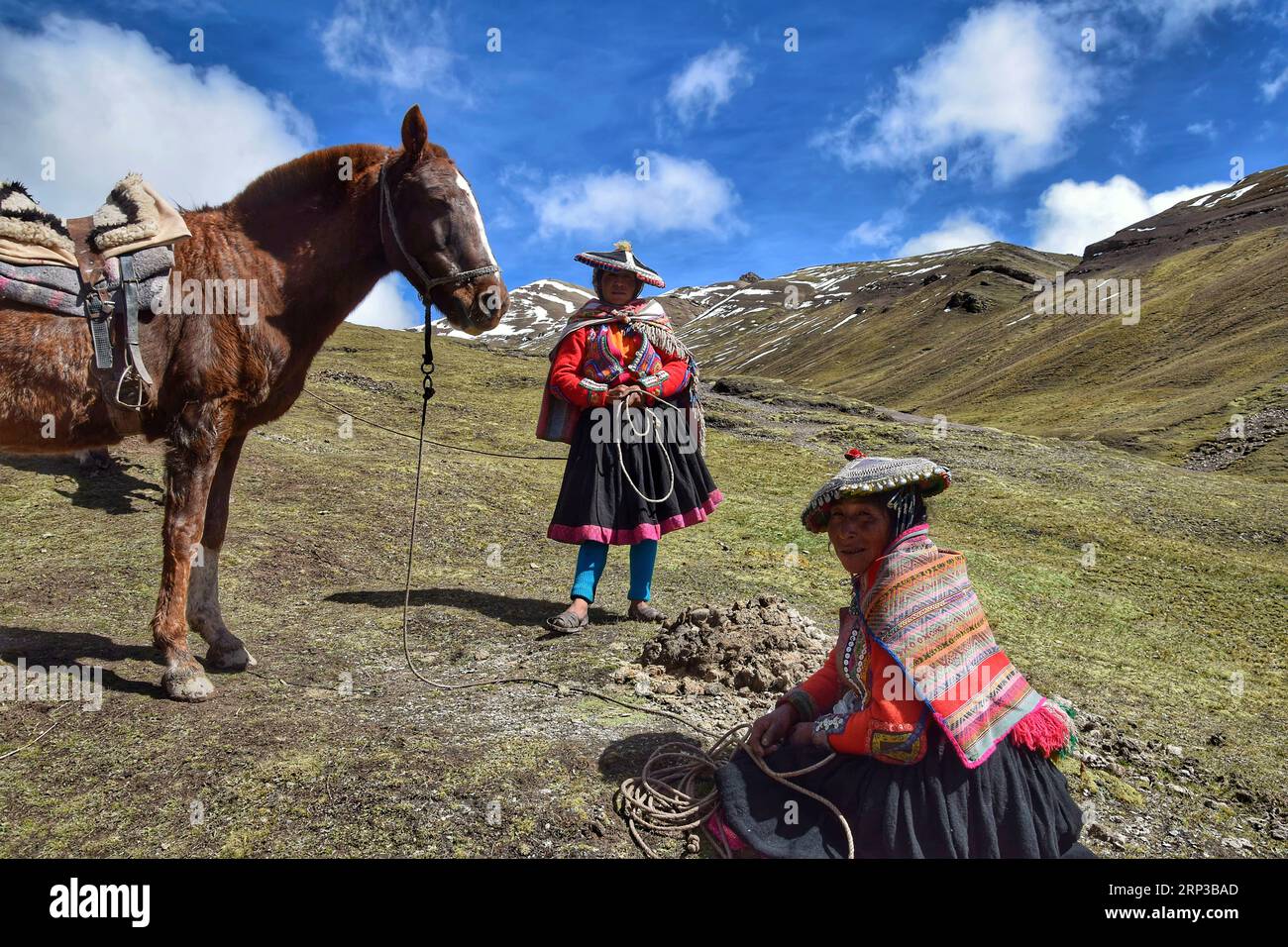 Traditional woman at the Vinicunca mountains near Cuzco Stock Photo