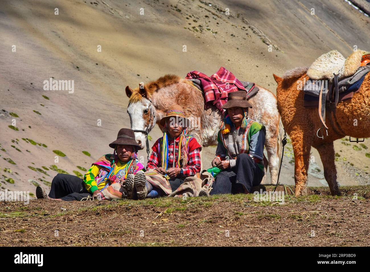 Traditional men at the Vinicunca mountains near Cuzco Stock Photo