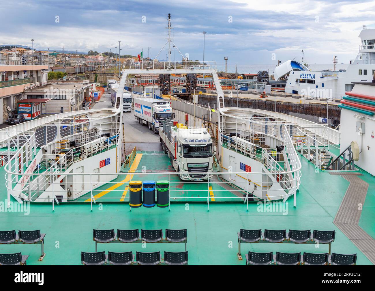 Trucks boarding car ferry in Villa San Giovanni, Calabria, Italy, ready for the short voyage to Messina, Sicily, Italy. Stock Photo