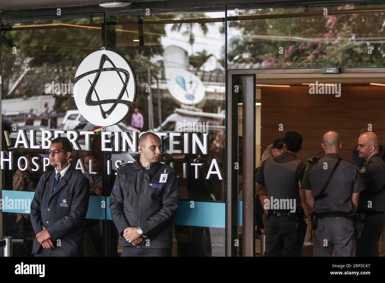 (180930) -- SAO PAULO, Sept. 30, 2018 -- Security personnel guard the entrance before the candidate from the Social Liberal Party (PSL, for its acronym in Spanish) for the Brazilian presidential elections, Jair Bolsonaro, leaves the Albert Einstein Israeli Hospital, in Sao Paulo, Brazil, on Sept. 29, 2018. Brazil s far-right presidential candidate and leader in the polls, Jair Bolsonaro, was discharged on Saturday after remaining 23 days hospitalized due to the attack he suffered during a campaign act, according to Sao Paulo s Albert Einstein Israeli Hospital.) (da) (cr) (qxy) BRAZIL-SAO PAULO Stock Photo