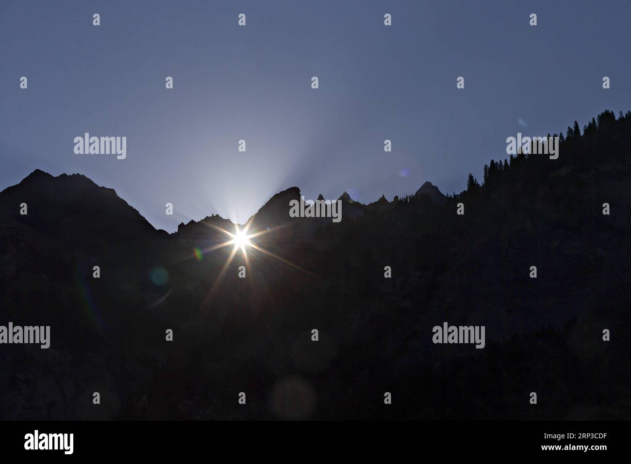 (180930) -- ELM, Sept. 30, 2018 -- The sun shines through the Martin s Hole directly onto Elm, in the Canton of Glarus, Switzerland, Sept. 30, 2018. The 22x19 meter wide rock window is located approximately 2,600m above sea level in the large Tschingelhorn mountain. This unusual phenomenon takes place for a few minutes shortly on several days in spring and autumn every year. ) (lrz) SWITZERLAND-ELM-MARTIN S HOLE MichelexLimina PUBLICATIONxNOTxINxCHN Stock Photo
