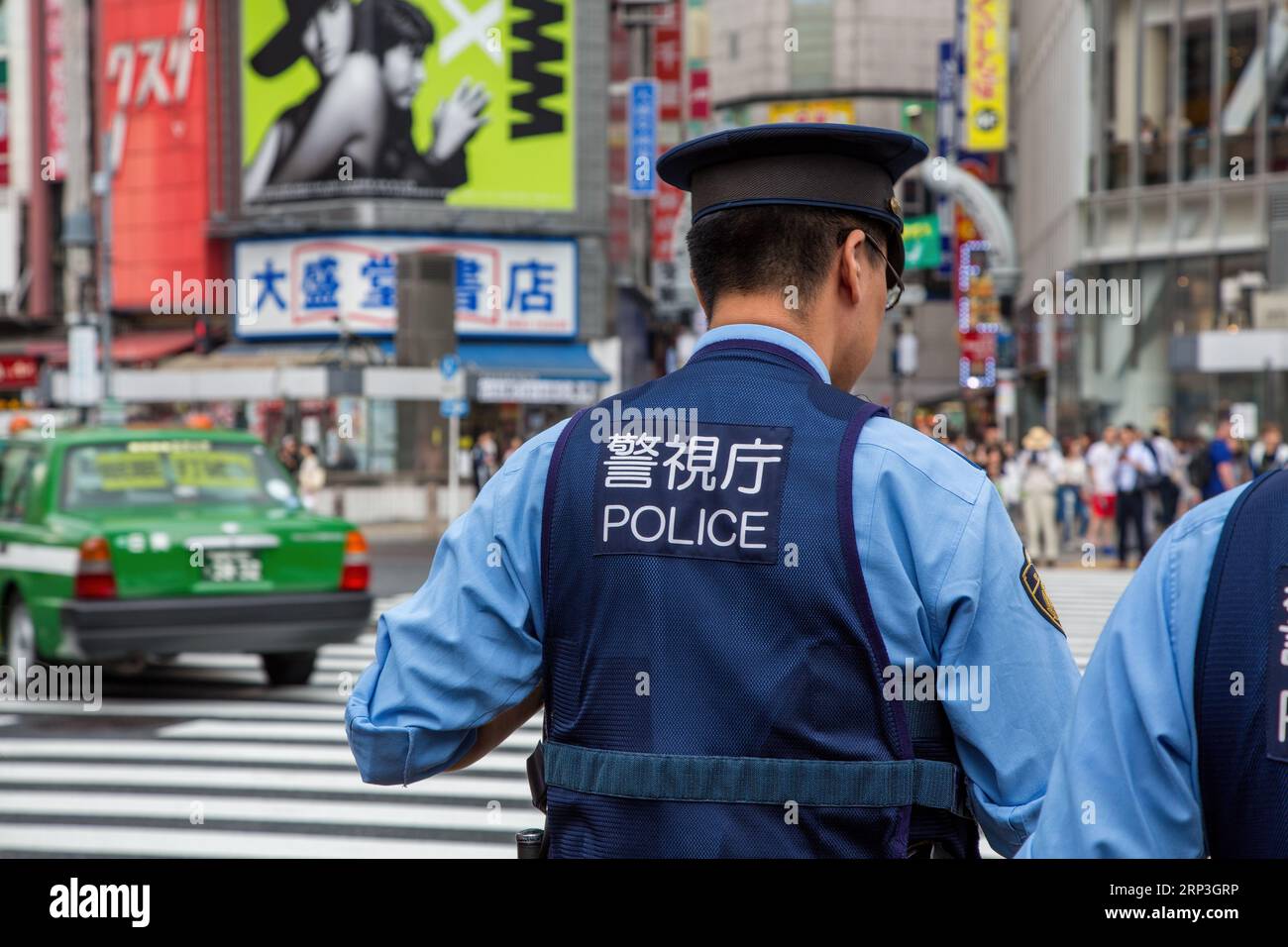 Tokyo, Japan - 21 June 2023: Japanese police presence at Shibuya Crossing, known as the scramble, the busiest pedestrian crossing in the world. Stock Photo
