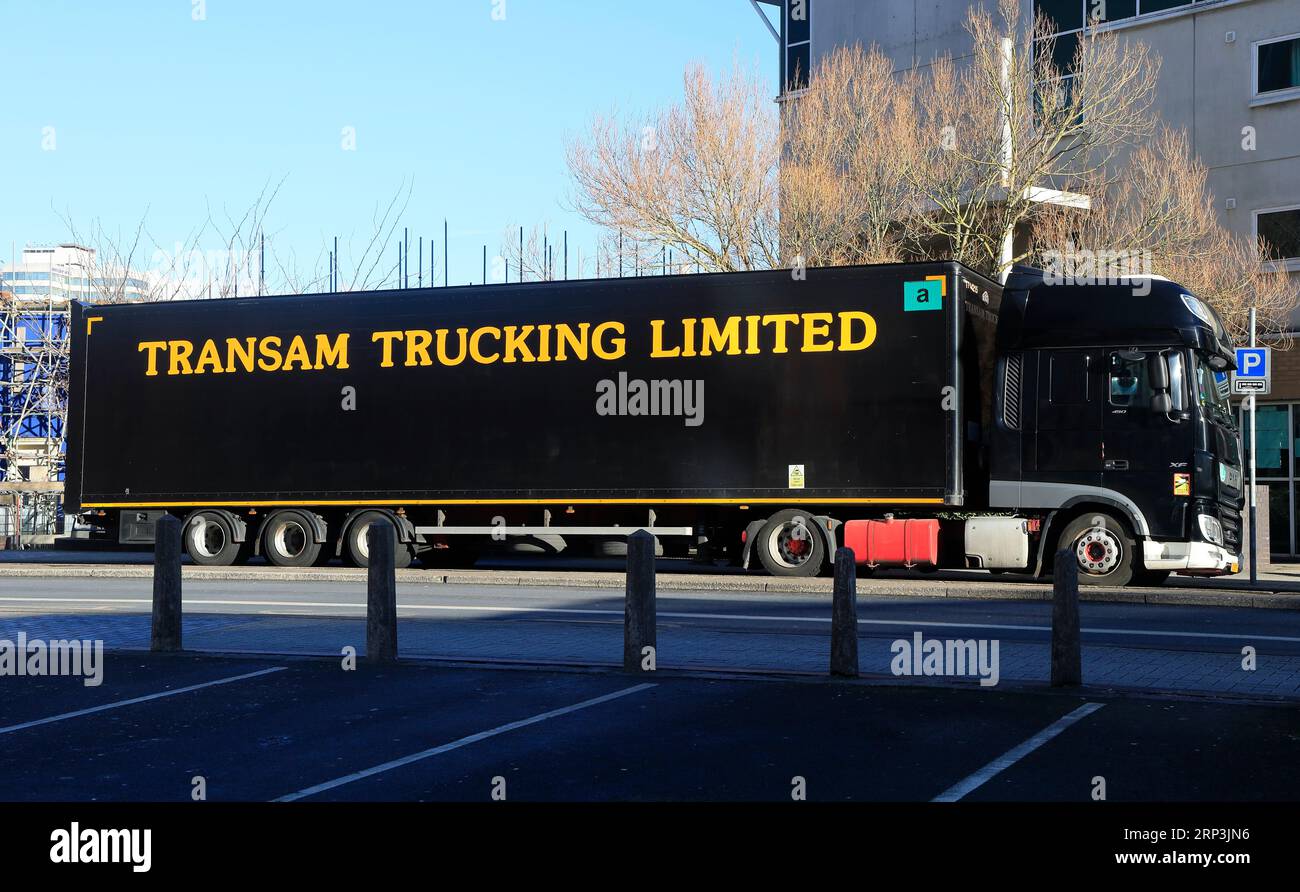 Transam Trucking Limited large black articulated lorry parked by the roadside, Cardiff City Centre. Stock Photo