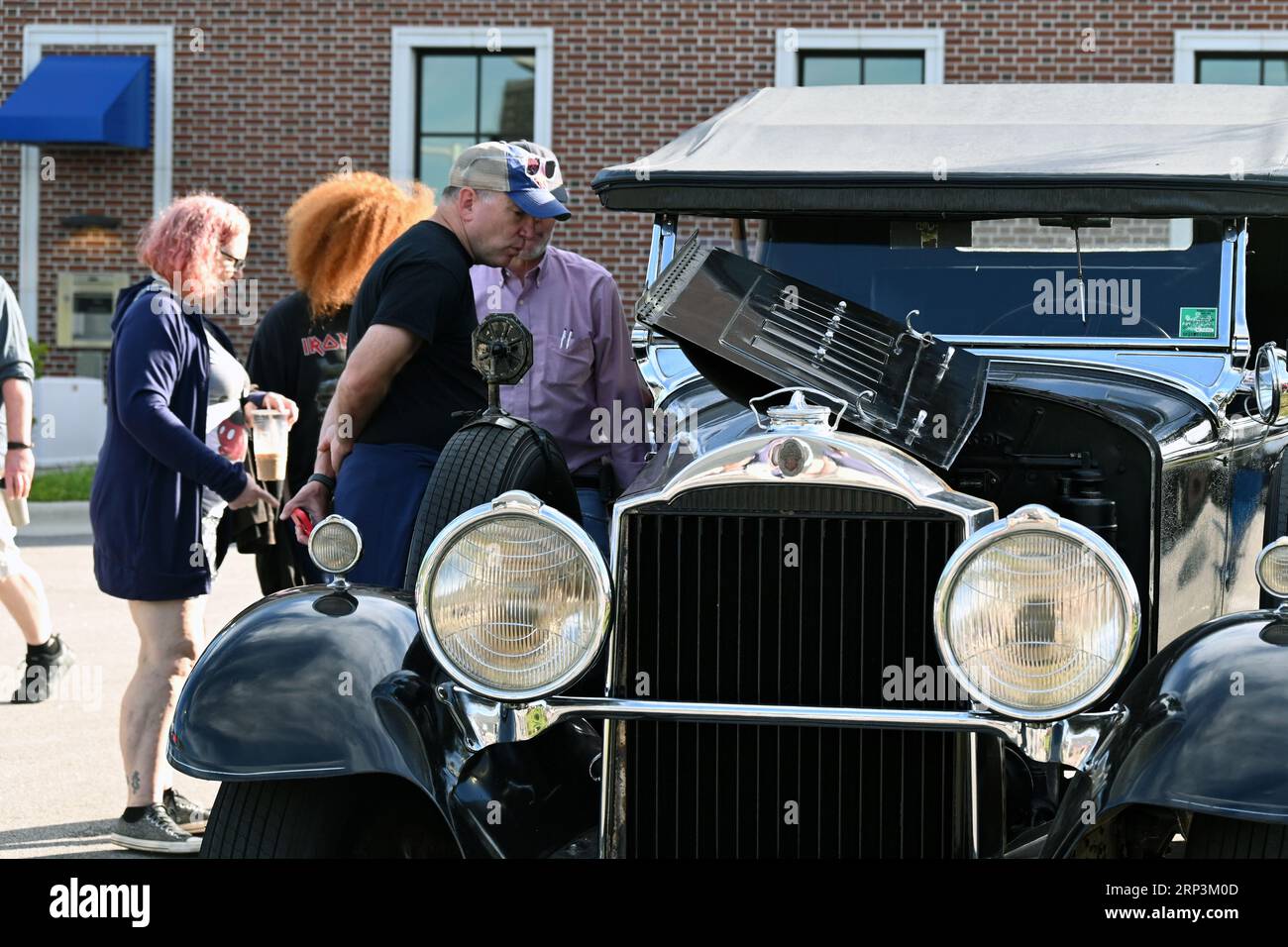 Durham, NC, USA, 2nd September 2023, Enthusiasts walk the parking lot to view over 2,000 vehicles at the monthly Morrisville Cars and Coffee event. Credit D Guest Smith Stock Photo