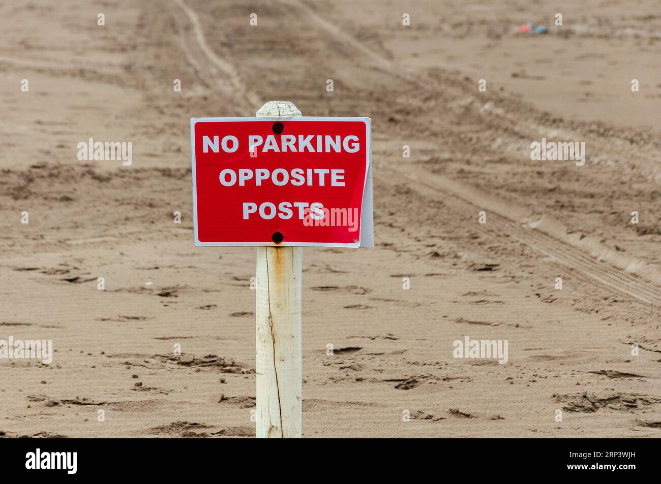 Sign on post saying No Parking opposite posts Stock Photo - Alamy